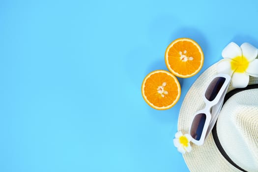 Beautiful summer holiday, Beach accessories, sunglasses, hat and orange on blue backgrounds
