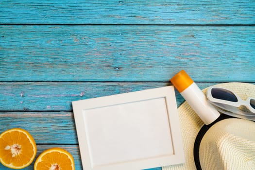 Beautiful summer holiday, Beach accessories, orange, sunglasses, hat and sunblock on wooden backgrounds