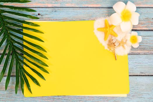 Beautiful summer holiday, Beach accessories, seashells, sand and palm leave on paper for copy space