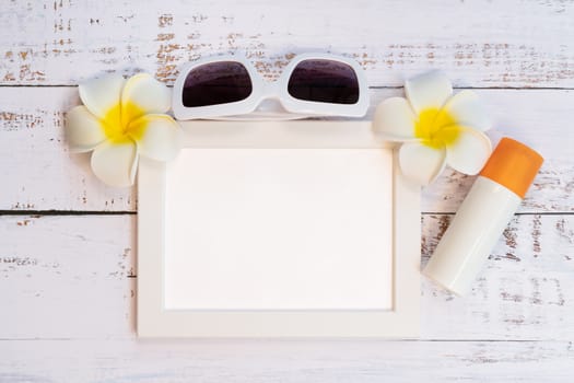 Beautiful summer holiday, Beach accessories, orange, sunglasses, flower and photo frame on wooden backgrounds
