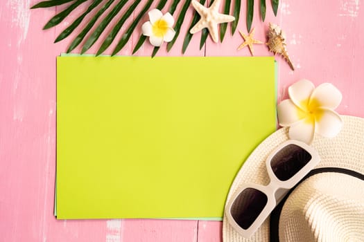 Beautiful summer holiday, Beach accessories, sea shells, hat, sunglasses and palm leave on paper for copy space