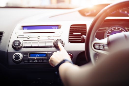 woman push turn on music radio in car