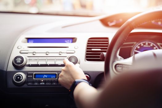 woman push turn on music radio in car