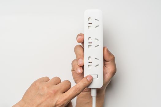 hand switch on/off socket plug electric power bar white color isolate. save energy and reduce energy efficiency concept