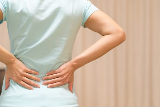 back pain at home. women suffer from backache. healthcare and medical concept