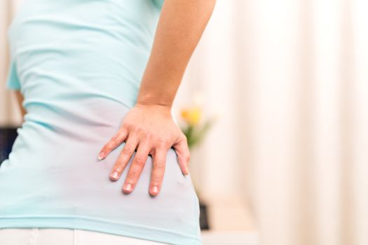 back pain at home. women suffer from backache. healthcare and medical concept