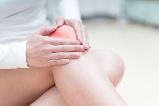 knee pain injury women sitting and touch her knee painful, healthcare and medicine concept