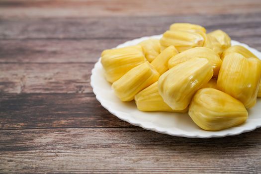 Fresh jackfruit slices on a white plate. sweet yellow jackfruit ripe. vegetarian, vegan, raw food. Exotic tropical fruit - isolated