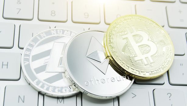 cryptocurrency coins - Litecoin, Bitcoin, Ethereum, Ripple cryptocurrency concept stock of physical bitcoins gold and silver coins