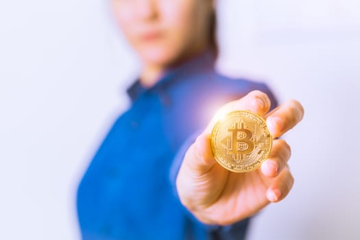 cryptocurrency coins - Bitcoin, Ethereum, Litecoin, Ripple. Women hold the cryptocurrency coin on hand. Physical bitcoins gold and silver coins