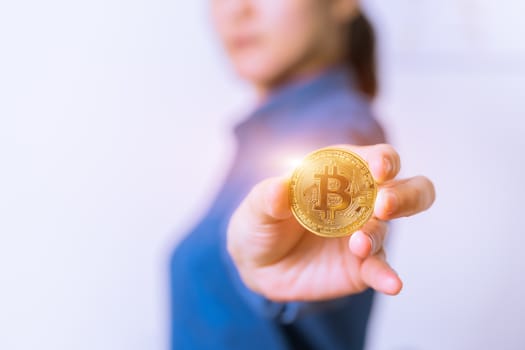 cryptocurrency coins - Bitcoin, Ethereum, Litecoin, Ripple. Women hold the cryptocurrency coin on hand. Physical bitcoins gold and silver coins