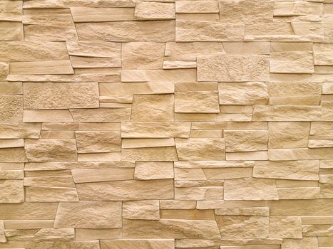 Modern sandstone stone wall background texture.