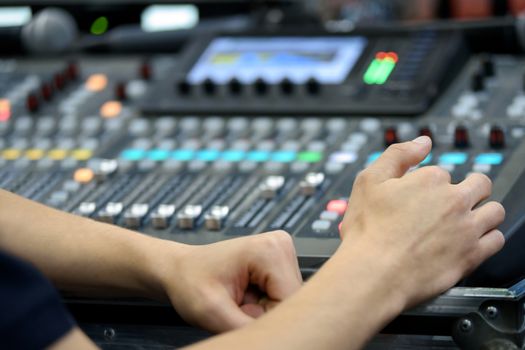 Director working on the video or sound mixing console in the studio