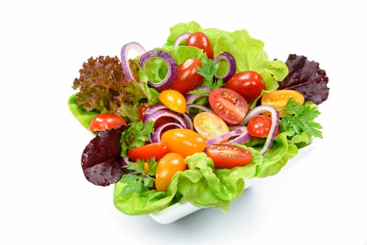 Fresh mixed vegetable salad in a bowl on a white background.
