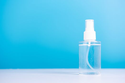 Plastic dispenser sanitizer alcohol spray bottle for washing hand hygiene prevention of coronavirus virus studio shot on blue background