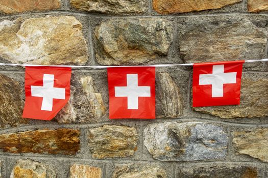 swiss flags on a stone hut