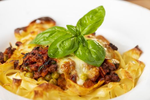 tagliatelle baked with cheese on a plate