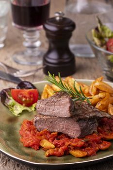 grilled steak on a plate with rosemary