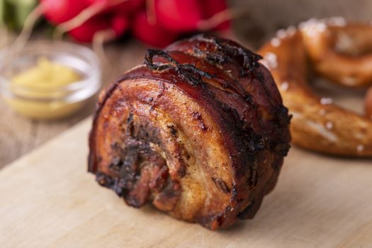 grilled rolled pork on a cutting board