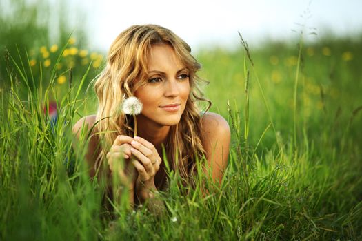 Girl with dandelion on spring meadow i wish concept