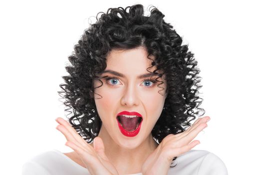 Portrait of beautiful curly hair brunette girl isolated on white background. Surprised emotional face, open mouth.