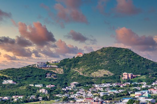 A green, tropical island covered with colorful condominiums