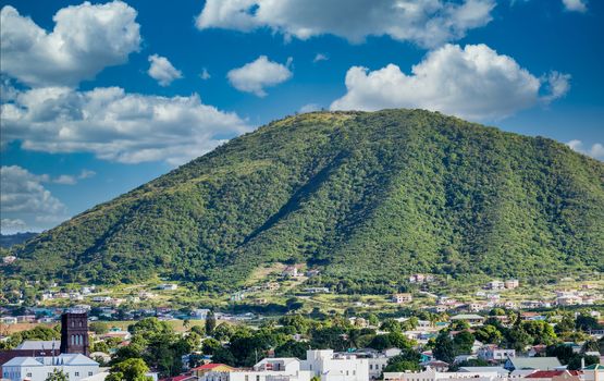 Green hill overlooking port town on St Kitts