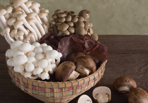 Baskets of assorted mushrooms on wooden table
