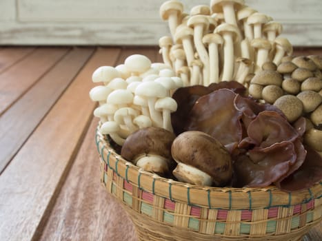 Baskets of assorted mushrooms on wooden table