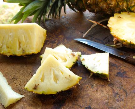 Pineapple slices on a wooden cutting board