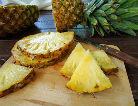 Pineapple slices on a wooden cutting board