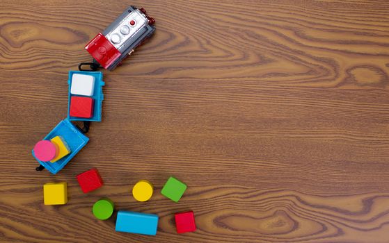 A toy train hauling color blocks