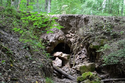 The collapsed edge of the road from the rain. Akyduct for water runoff.