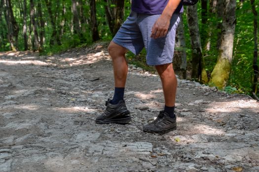 The detached sole on the tourist's sneakers. They broke their boots in the woods.
