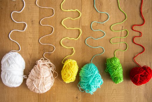 knitted thread on wooden background