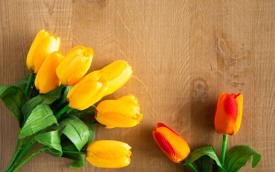 Tulips bunch on wooden background. Space for text.