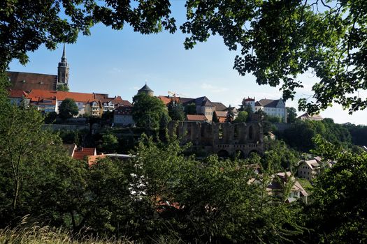 The old town of Bautzen, Germany hidden behind trees and bushes