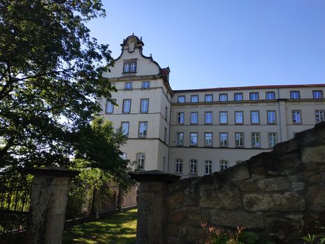 Sonnenstein castle behind wall and trees in Pirna, Germany