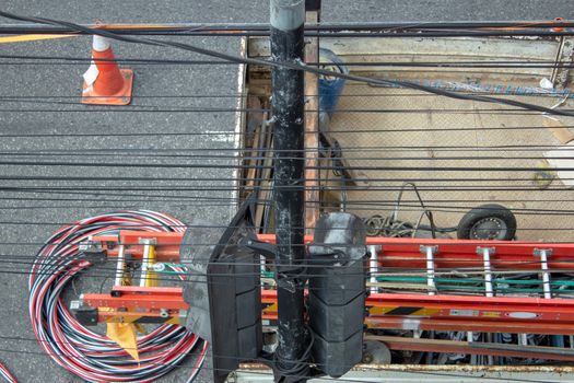 Truck full of equipments of a electrical company while doing a repair job on the grid