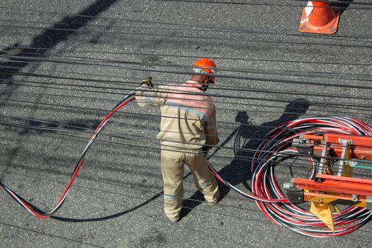 Men repairing electrical grid wires using masks because of COVID-19