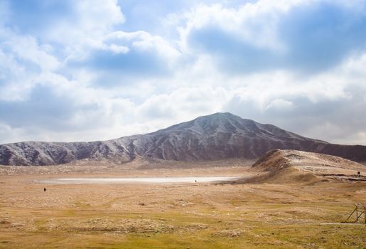 Mount Aso and Kusasenri in winter. covered by golden yellow grassland - Kumamoto, Japan