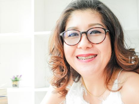 Beautiful woman smiling happy against white background.
