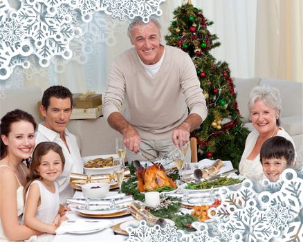 Grandfather cutting turkey for Christmas dinner against snowflake frame