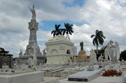 View of the Necropolis of Cristobal Colon, Havana, Cuba. The City's main cemetery has many historic monuments and memorials. The tall pillar to the left commemorates Havana's firefighters.