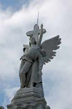 Sculpture of an angel taking a fallen firefighter to heaven.  Detail of the firemen monument, The Monumento a los Bomberos in Havana's Christopher Columbus cemetary, known as  La Necrópolis de Cristóbal Colón, is a memorial to the 28 firemen killed tackling a fire in the old part of the city in 1890.  