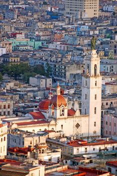 View from a tall building of the Convent and church of Carmen, with its belltower topped with a statue of Nuestra Señora del Carmen in the Central Havana district of Cuba's capital city. 