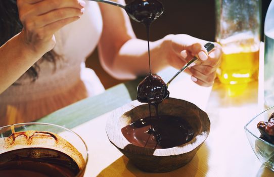 Staying at home woman preparing handmade vegetarian chocolate truffles