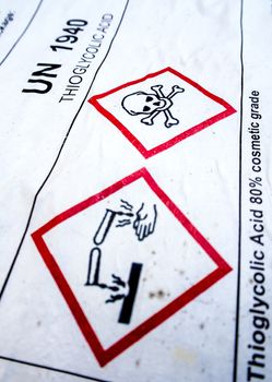 Warning symbol of corrosive material at the acid container