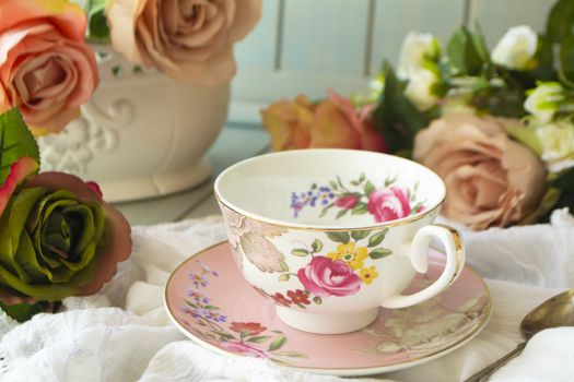 Vintage tea cup, frame of pastel roses flowers