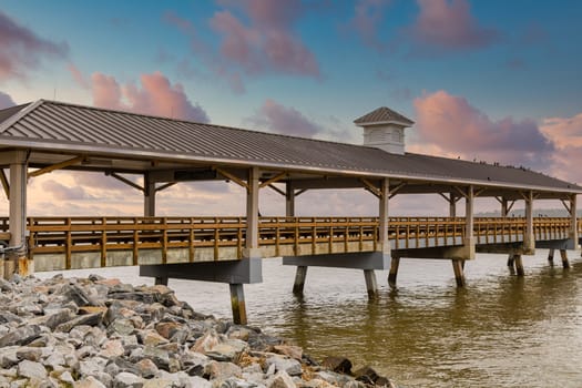 An old wood and conrete pier under cloudy skies